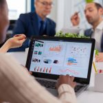 Multi-ethnic business team sitting at table in office center speaking